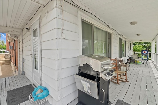 wooden deck with grilling area and a porch