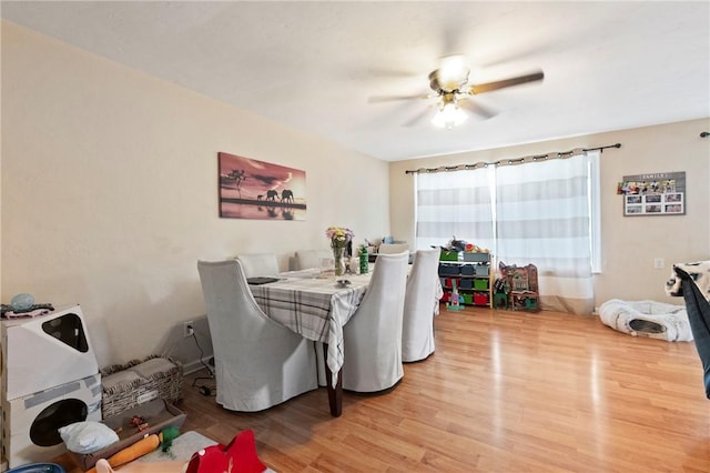 dining room with light wood finished floors and a ceiling fan