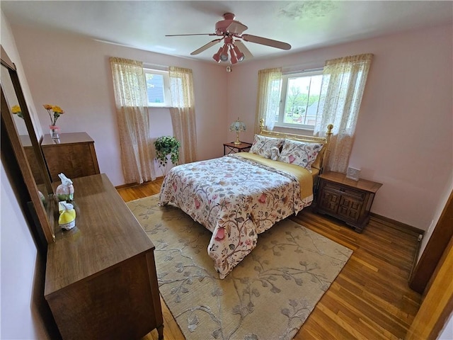 bedroom with light wood-type flooring and ceiling fan