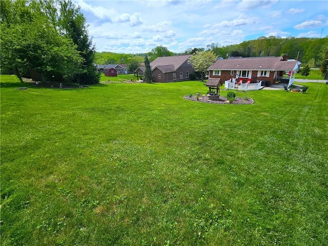 view of green lawn featuring a patio area