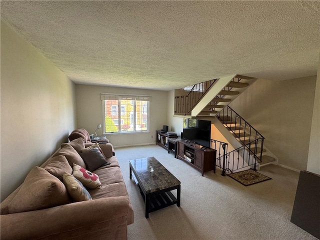 109 Canterbury Commons Unit 109, White Twp Ind, PA 15701 - living area featuring a textured ceiling, carpet, stairs, and baseboards