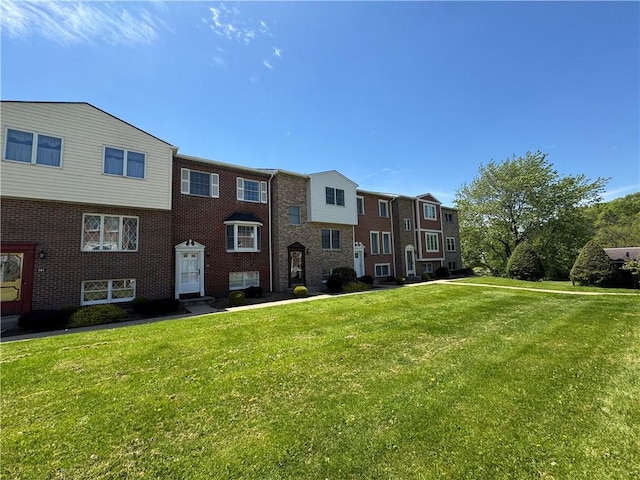 109 Canterbury Commons Unit 109, White Twp Ind, PA 15701 - view of front facade featuring a front yard and brick siding