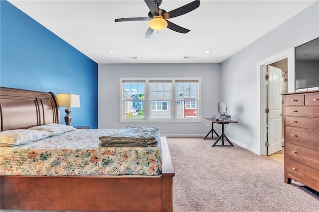 carpeted bedroom featuring baseboards and a ceiling fan