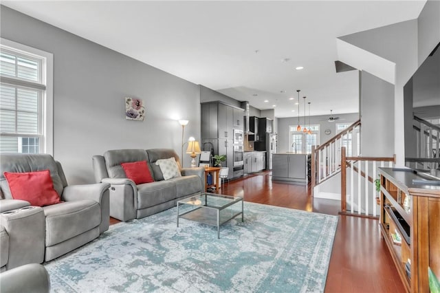living area featuring plenty of natural light, dark wood-style floors, stairs, ceiling fan, and recessed lighting