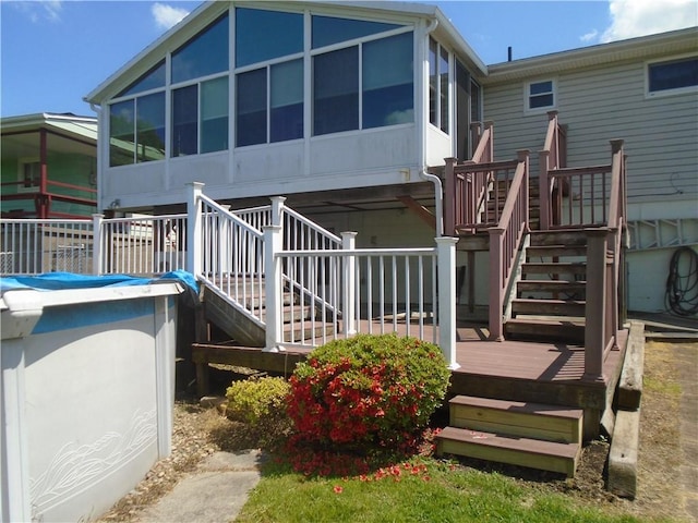 1040 Catherine Dr, Conway, PA 15027 - rear view of property featuring stairway, a sunroom, and a deck