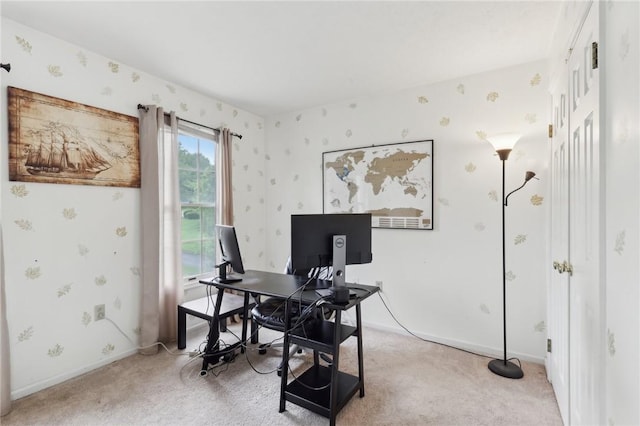 office area with wallpapered walls, light colored carpet, and baseboards