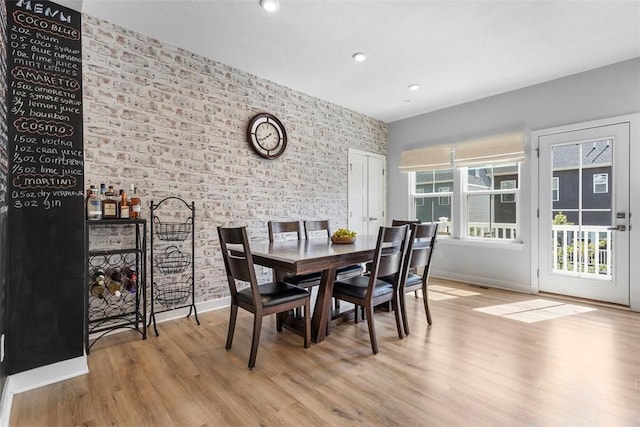 4012 Crown Dr, South Park, PA 15129 - dining area featuring brick wall, wood finished floors, baseboards, an accent wall, and recessed lighting
