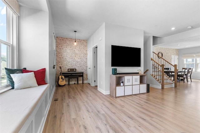 4012 Crown Dr, South Park, PA 15129 - living room with light wood finished floors, brick wall, and stairway
