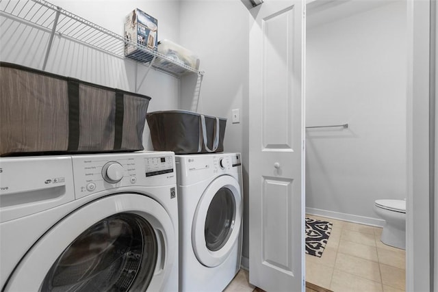 4012 Crown Dr, South Park, PA 15129 - laundry room with washer and clothes dryer, light tile patterned flooring, and baseboards