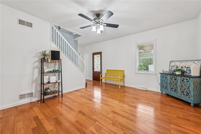 2939 Main St, Beallsville, PA 15313 - unfurnished living room featuring stairs, wood finished floors, ceiling fan, and baseboards