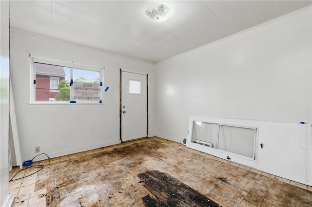 entryway with healthy amount of natural light and ornamental molding