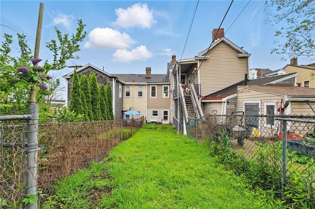rear view of house featuring a chimney