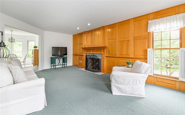 living area with light colored carpet, a fireplace, and recessed lighting