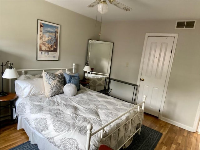 bedroom with wood finished floors, baseboards, and ceiling fan