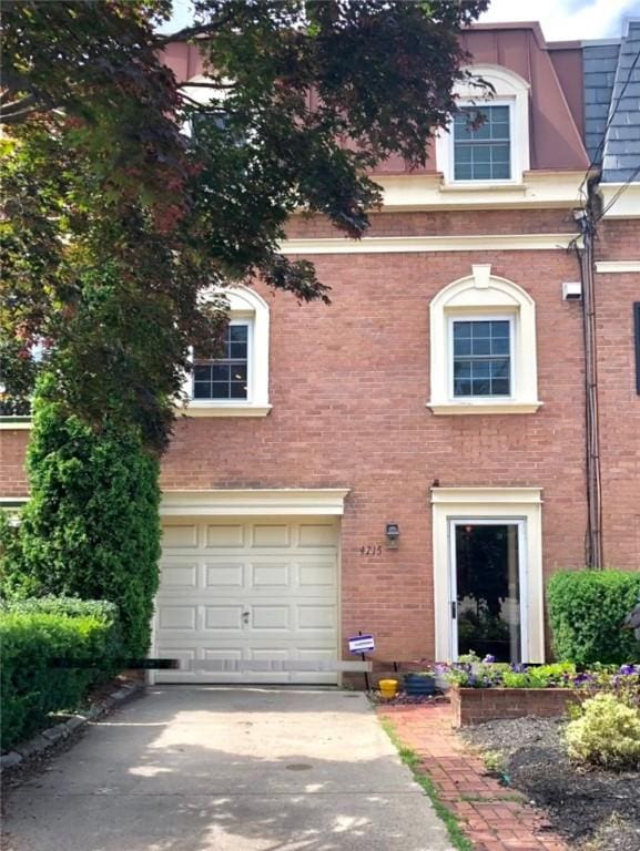 view of front of property featuring a garage, brick siding, and concrete driveway