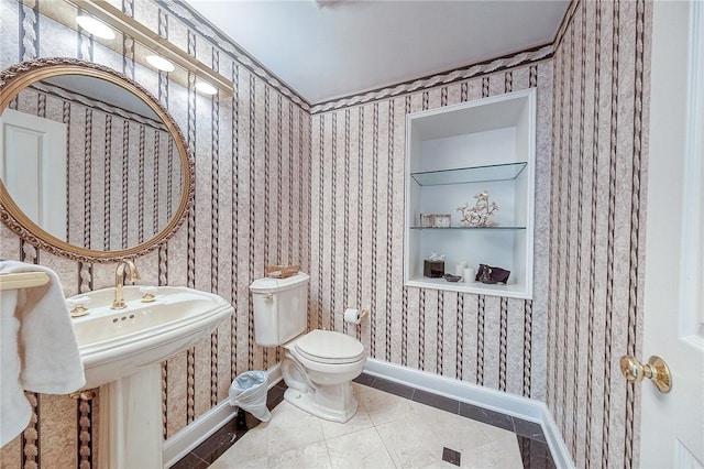 bathroom featuring baseboards, wallpapered walls, toilet, built in shelves, and tile patterned flooring