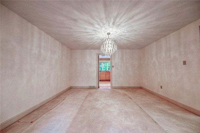 unfurnished room with a chandelier and light colored carpet