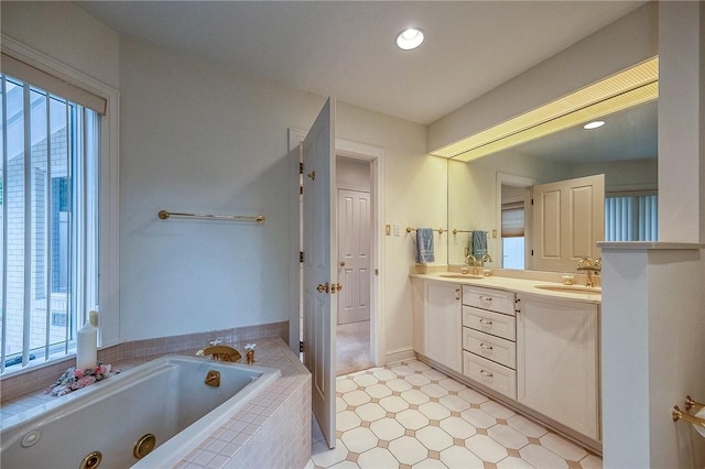 bathroom featuring double vanity, a jetted tub, and tile patterned floors