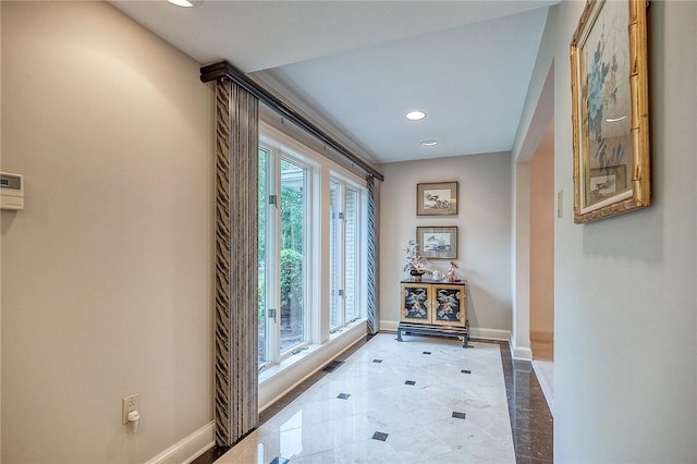 doorway featuring baseboards and recessed lighting