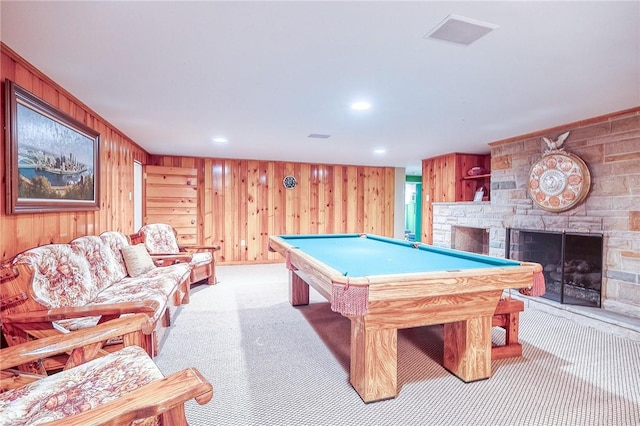 playroom with a stone fireplace, wooden walls, light colored carpet, billiards table, and recessed lighting