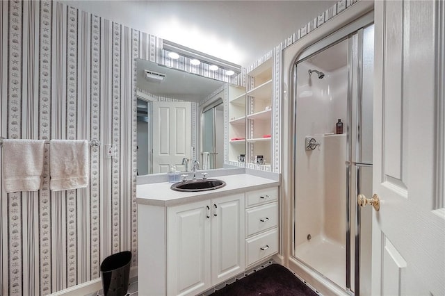 bathroom with a stall shower and vanity