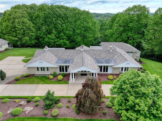 view from above of property featuring a heavily wooded area