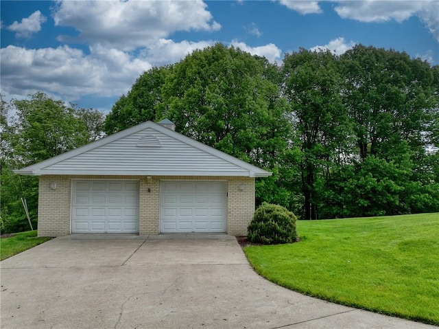 detached garage featuring view of scattered trees
