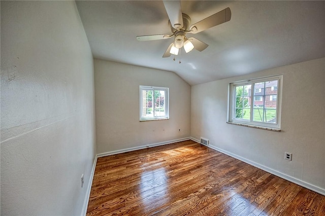 1593 Riverside Dr, Penn Hills, PA 15147 - spare room featuring lofted ceiling, wood finished floors, baseboards, and a ceiling fan