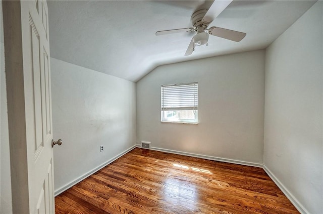 1593 Riverside Dr, Penn Hills, PA 15147 - spare room with vaulted ceiling, wood finished floors, a ceiling fan, and baseboards