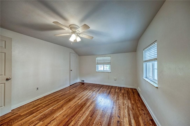 1593 Riverside Dr, Penn Hills, PA 15147 - empty room featuring lofted ceiling, wood finished floors, baseboards, and a ceiling fan