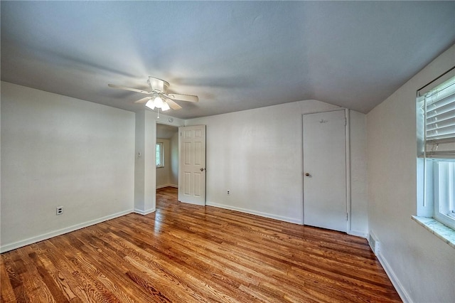 1593 Riverside Dr, Penn Hills, PA 15147 - unfurnished bedroom with wood finished floors, lofted ceiling, baseboards, and a ceiling fan