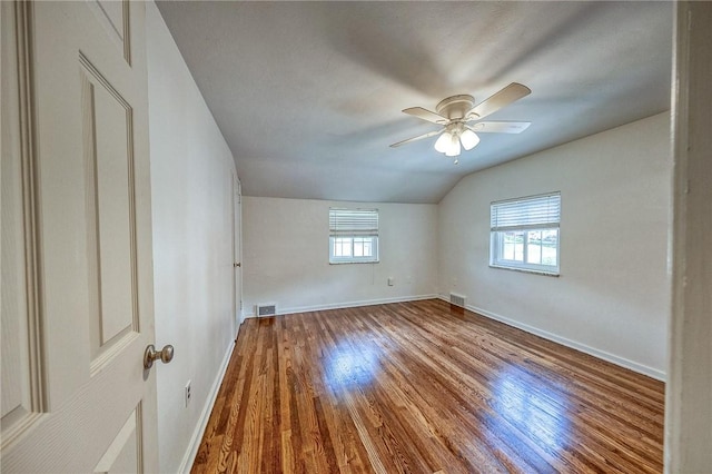 1593 Riverside Dr, Penn Hills, PA 15147 - spare room with lofted ceiling, wood finished floors, baseboards, and a ceiling fan