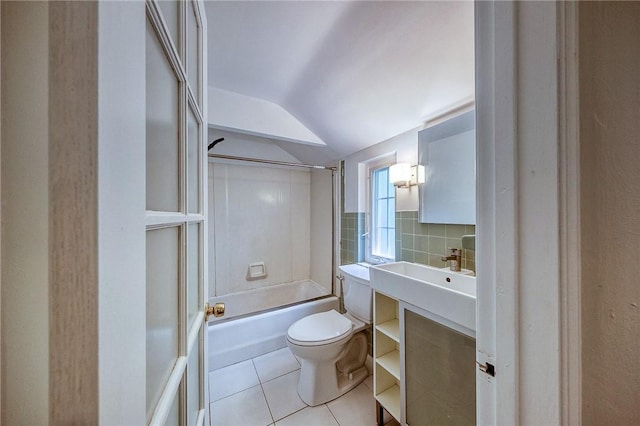 1593 Riverside Dr, Penn Hills, PA 15147 - full bath featuring tile patterned flooring, toilet, lofted ceiling,  shower combination, and tile walls