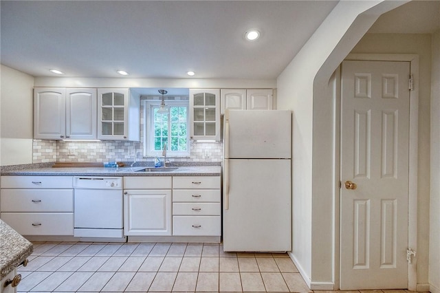 1593 Riverside Dr, Penn Hills, PA 15147 - kitchen featuring white appliances, a sink, white cabinetry, glass insert cabinets, and tasteful backsplash
