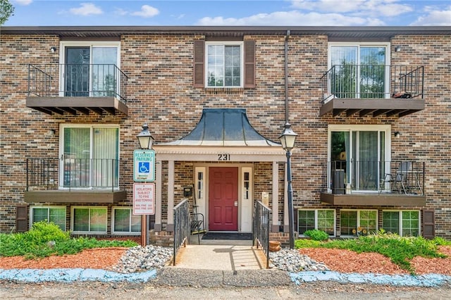 townhome / multi-family property featuring brick siding