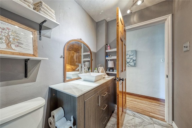 1814 Roosevelt Rd, Ohio Twp, PA 15143 - half bathroom featuring marble look tile flooring, toilet, vanity, and baseboards