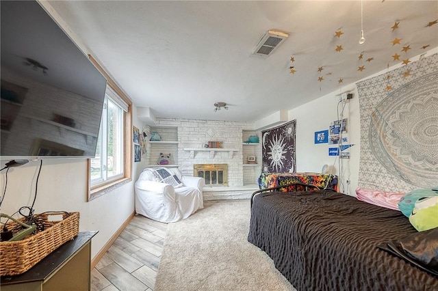 1814 Roosevelt Rd, Ohio Twp, PA 15143 - bedroom with baseboards, a large fireplace, and light wood-style floors