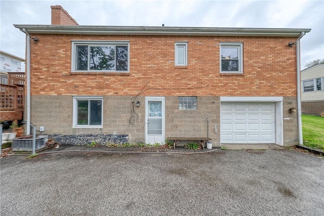 1814 Roosevelt Rd, Ohio Twp, PA 15143 - view of front of home featuring a garage, a chimney, asphalt driveway, and brick siding