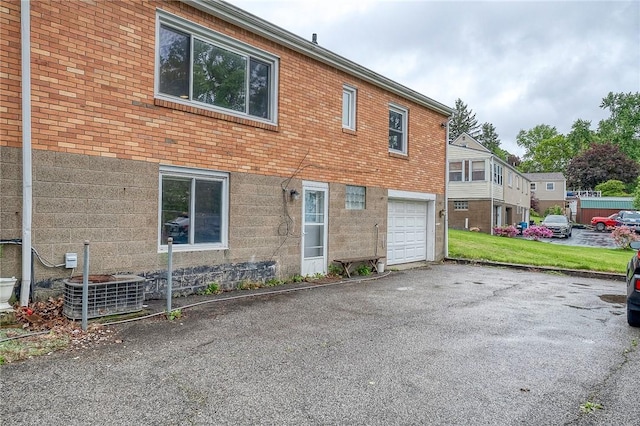 1814 Roosevelt Rd, Ohio Twp, PA 15143 - view of side of property featuring a garage, driveway, brick siding, and central air condition unit