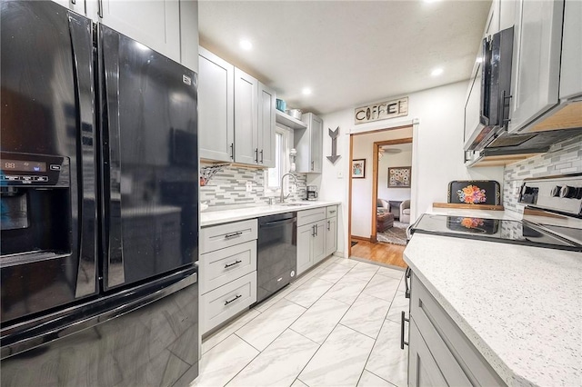 1814 Roosevelt Rd, Ohio Twp, PA 15143 - kitchen featuring black appliances, light countertops, recessed lighting, tasteful backsplash, and light marble finish flooring
