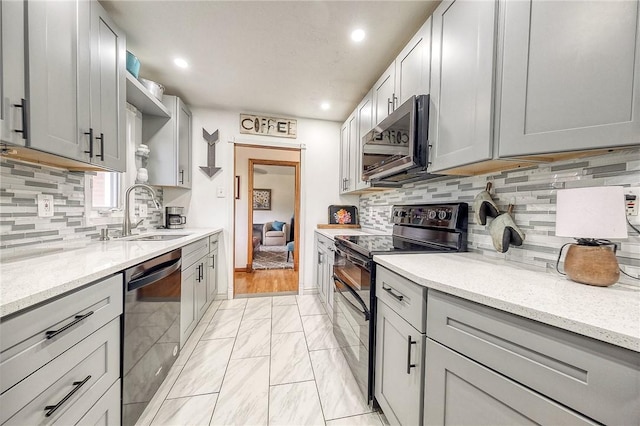 1814 Roosevelt Rd, Ohio Twp, PA 15143 - kitchen featuring appliances with stainless steel finishes, a sink, gray cabinets, light marble finish floors, and recessed lighting