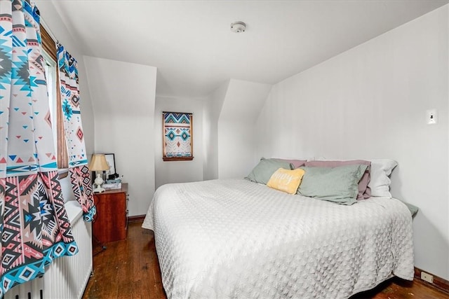 bedroom featuring wood finished floors and baseboards