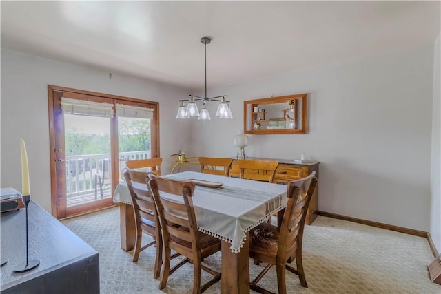 dining area featuring carpet and baseboards