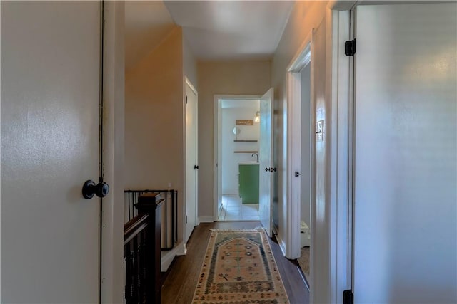 corridor featuring wood finished floors and baseboards