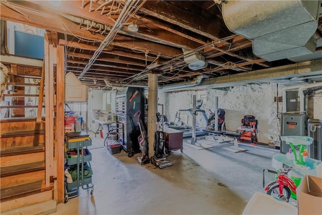 unfinished below grade area with heating unit and stairs