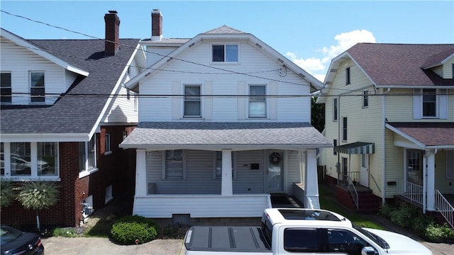 view of front of house featuring a porch and a chimney