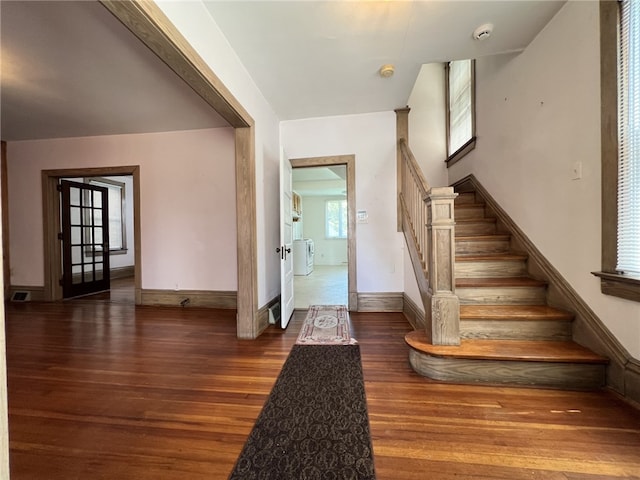 foyer featuring stairs, wood finished floors, and baseboards
