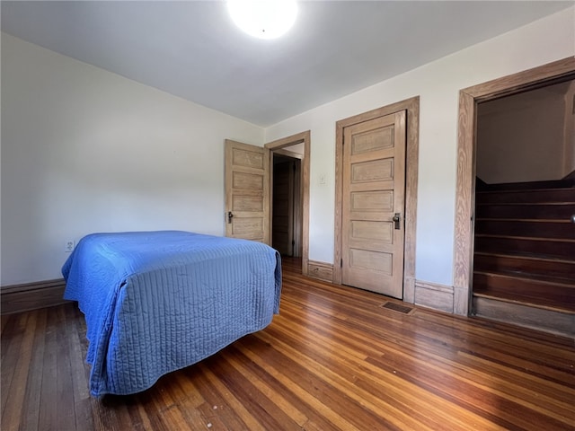 bedroom featuring hardwood / wood-style floors and baseboards