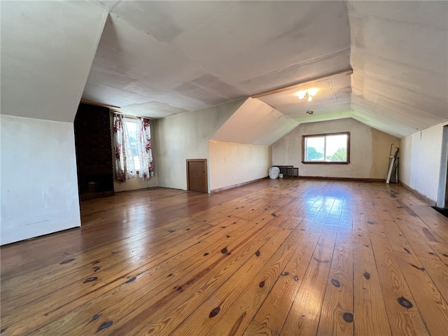 bonus room featuring wood-type flooring and vaulted ceiling