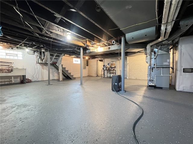 basement with stairway and heating unit
